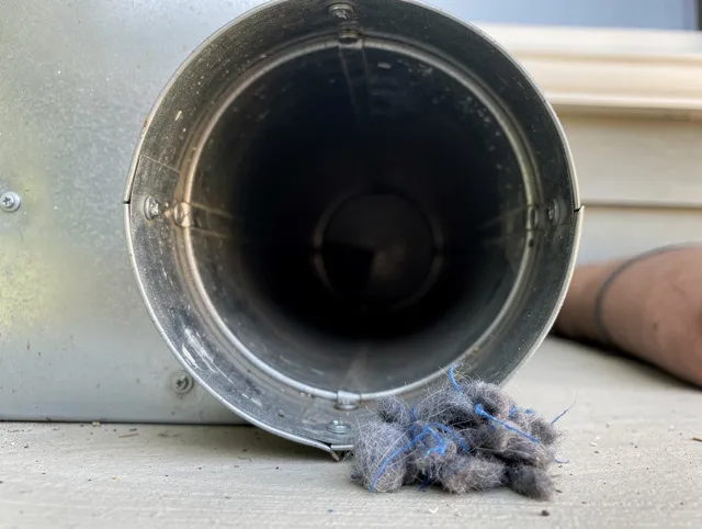 Newark Dryer Vent Cleaning technician using specialized equipment to clear severe dryer vent blockage in Newark